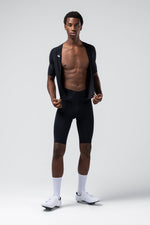 Male model wearing black Gobik cycling bib shorts with matching top