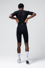 Man wearing black Gobik Integral Hudson cycling outfit from behind
