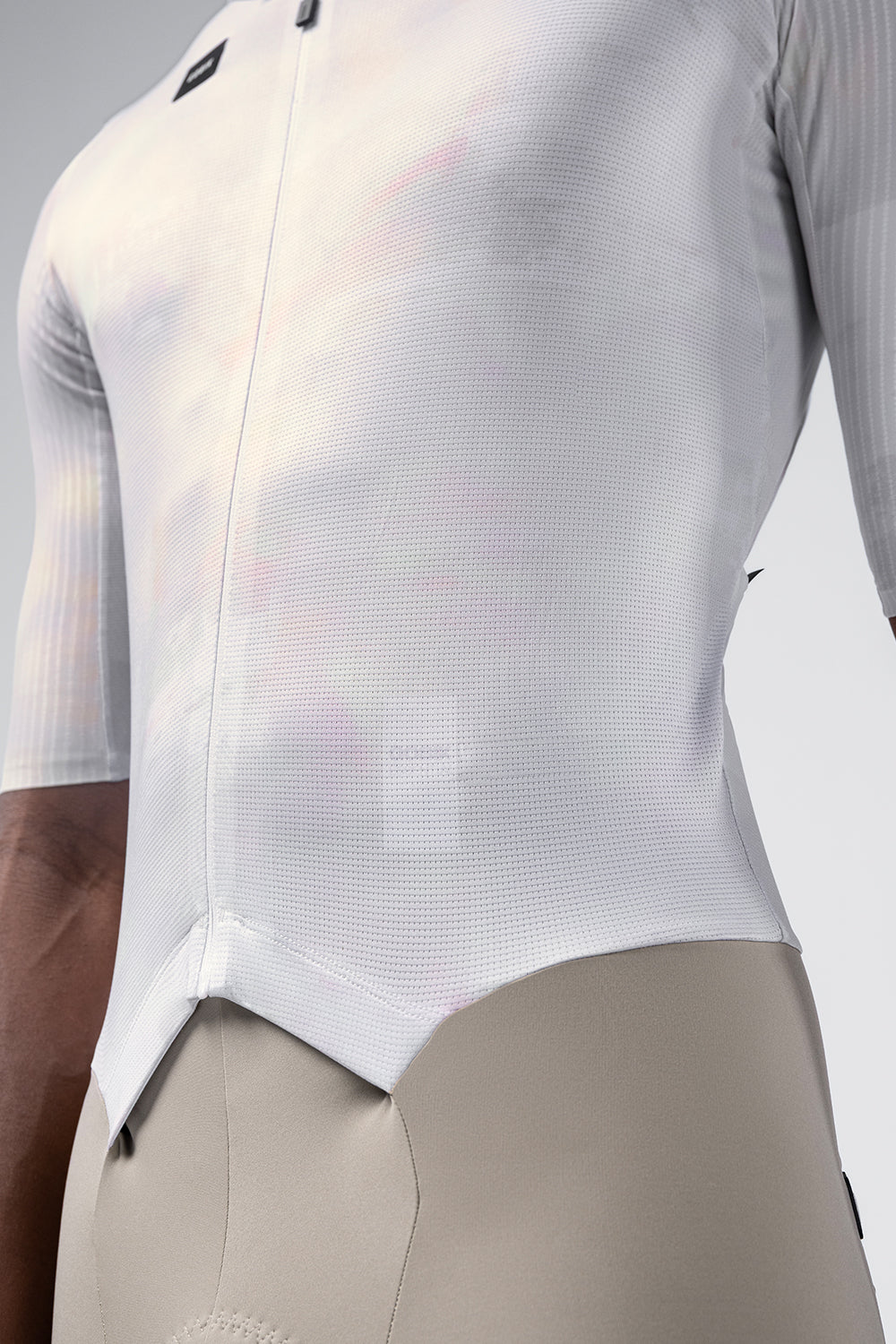 Side torso detail of Gobik Aerosuit Madison showing white Crisp fabric texture and curved hem design