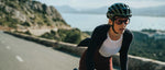 Cyclist wearing black Kask Valegro helmet while riding on scenic coastal road