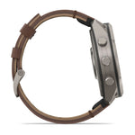 Side profile view of Garmin Fenix 9 Pro titanium smartwatch with walnut leather band and three buttons