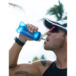 Athlete drinking from Fitletic Flow Max blue soft flask 350ml during outdoor run
