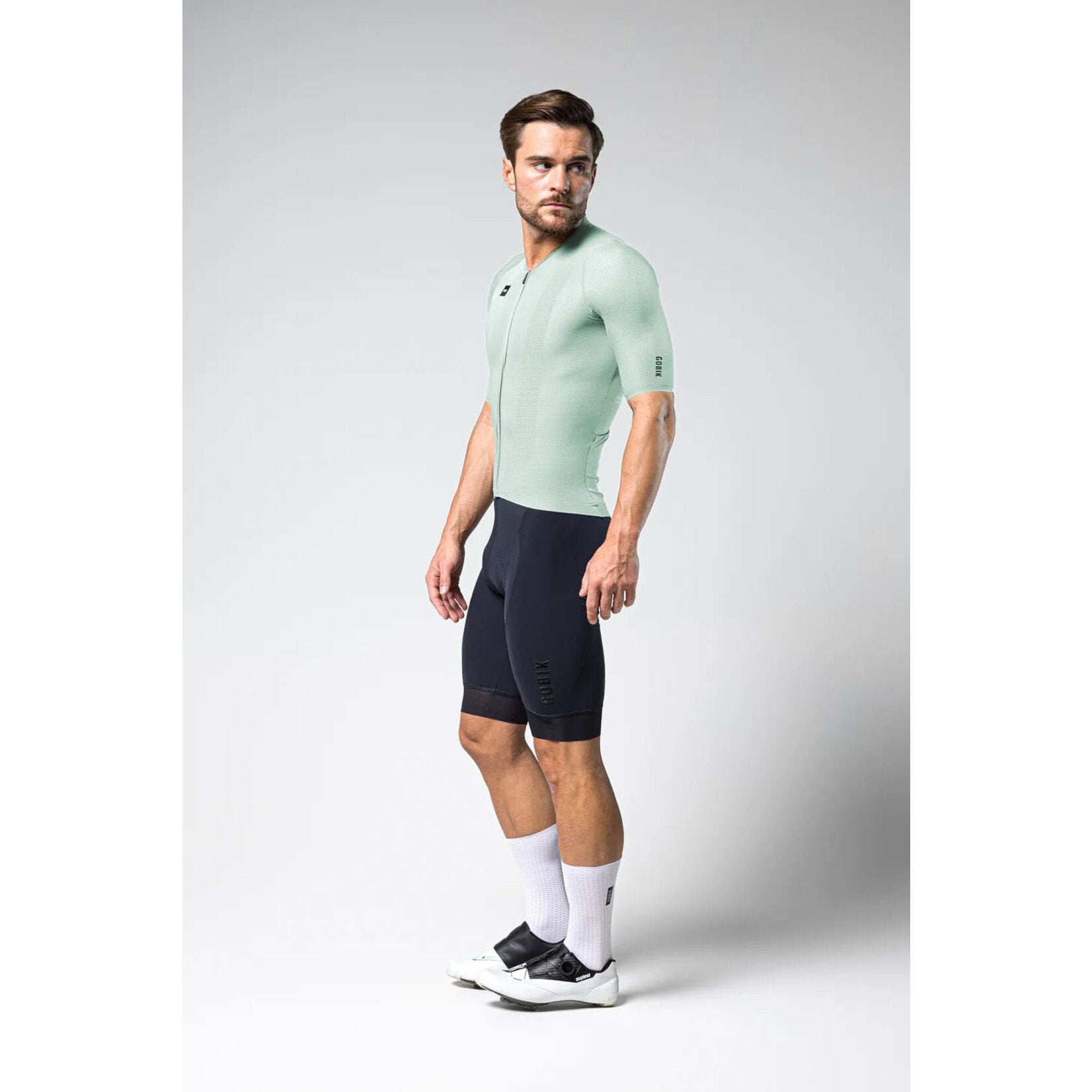 Male model wearing Gobik Phantom Jersey in bay green with black cycling shorts
