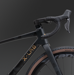 Close-up of X-LAB GT8 head tube and handlebars showing black geometric pattern and gold branding