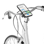 Nite Ize HandleBand clear smartphone mount attached to white bicycle handlebars with phone displaying map