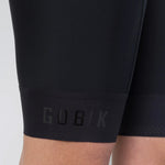 Close-up of Gobik Limited 6.0 black bib shorts leg hem with embossed GOBIK brand name