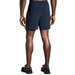 Brooks Moment 7-inch men's running shorts in navy with orange side stripe, rear view