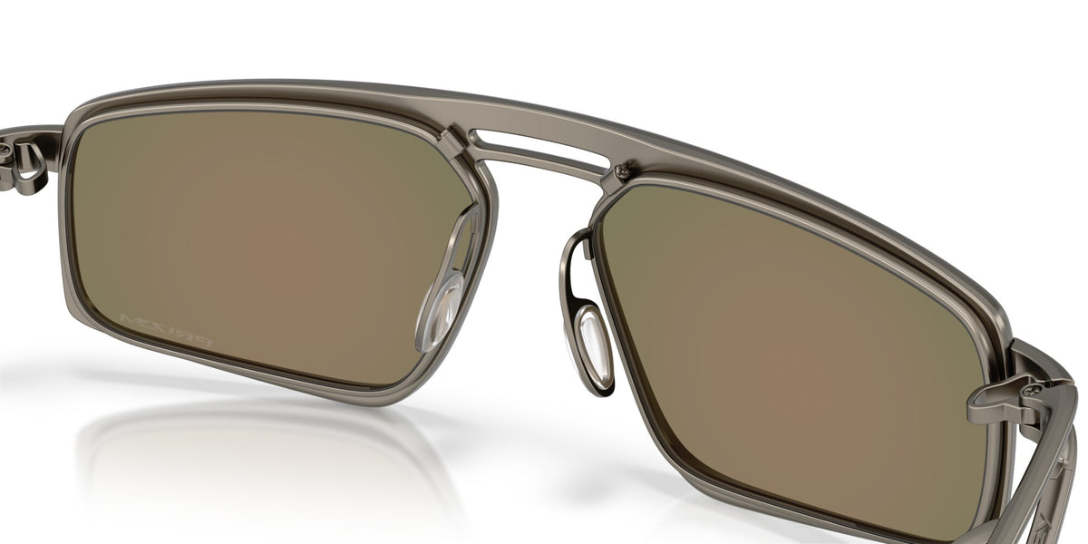 Close-up detail of Oakley Bushwick sunglasses showing gunmetal frame and nose bridge construction