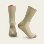 Velocio cycling socks in tan color with colorful striped cuff on white background