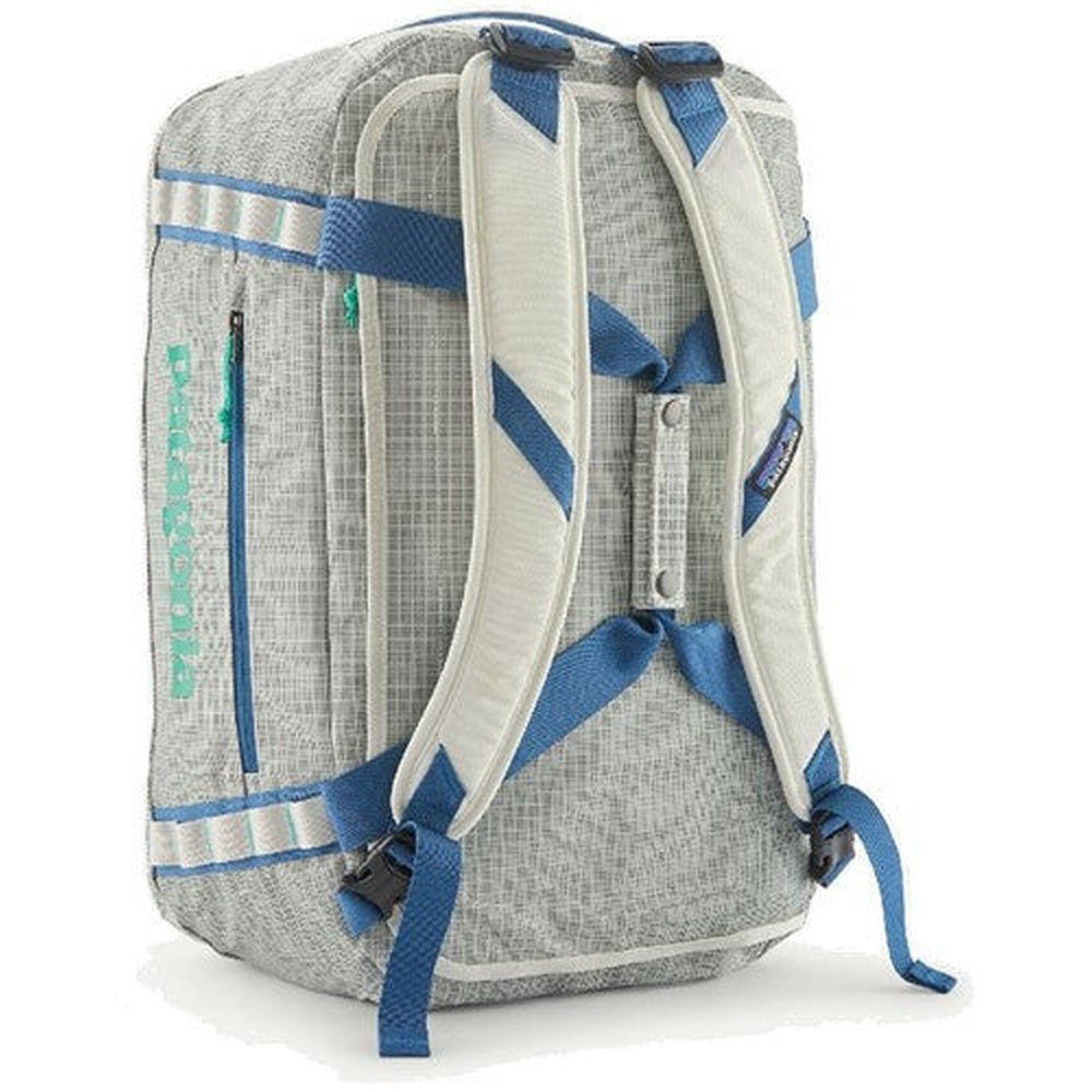 Patagonia Black Hole Duffel in Birch White with blue straps, shown from rear angle