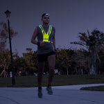 Male runner wearing Fitletic Ray headlamp and reflective vest during night run outdoors