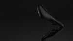 Specialized S-Works Power Evo Mirror saddle dramatic dark studio shot showing 3D lattice surface and carbon rails