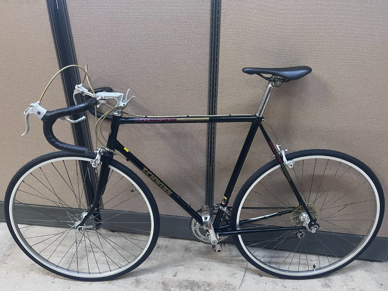 Schwinn World Sport road bike side profile showing black 4130 Cr-Mo steel frame and drop bars