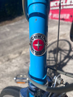 Schwinn head badge on the blue head tube of the vintage Le Tour Mixte bike