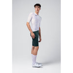 Male cyclist wearing Gobik Limited Edition Attitude white jersey with dark green bib shorts