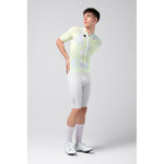 Male model wearing Gobik CX Pro cycling jersey with yellow-green pattern and white shorts