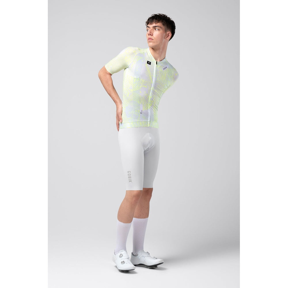 Male model wearing Gobik CX Pro cycling jersey with yellow-green pattern and white shorts