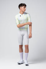 Male model wearing Gobik CX Pro cycling jersey in white with neon geometric pattern