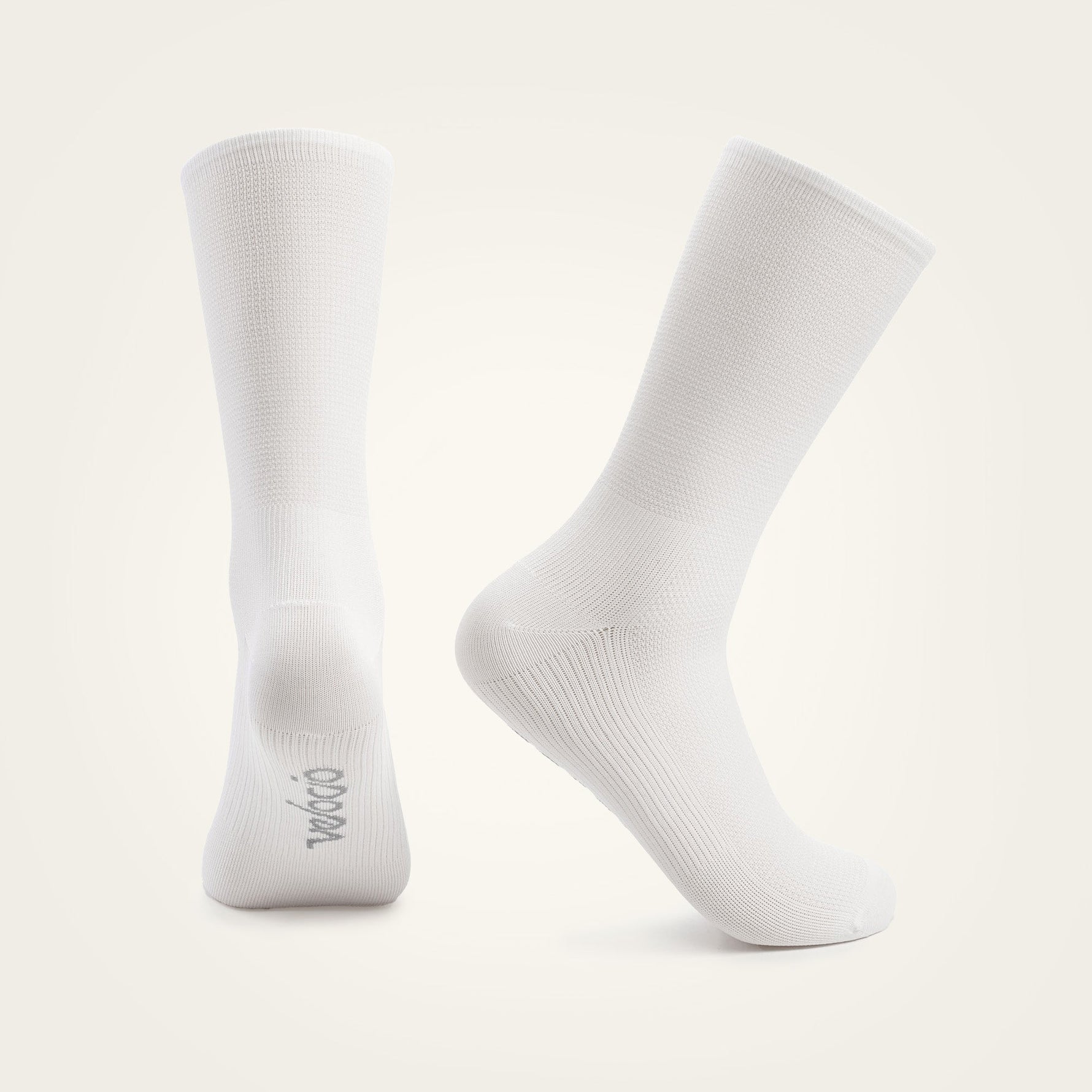 Two white Velocio Ultralight cycling socks displayed against neutral background